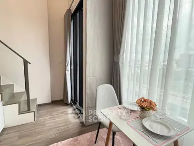 Modern living room with dining area and large window offering city view