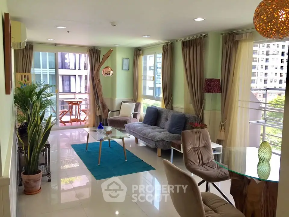 Spacious modern living room with large windows and stylish furniture in a high-rise apartment.
