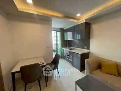 Modern open-layout kitchen and living area with sleek design and natural light.