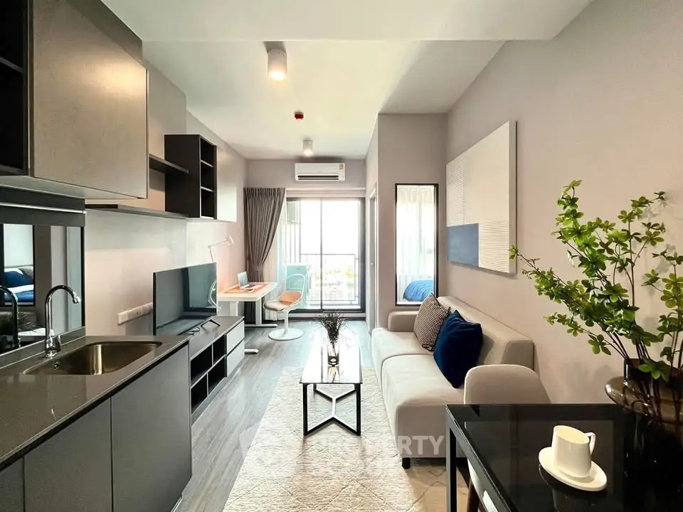 Modern living room with sleek design, open kitchen, and balcony access in a stylish apartment.