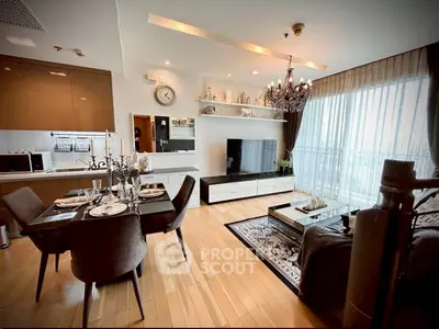 Luxurious open-plan living room with elegant dining area and modern kitchen in a high-end apartment.