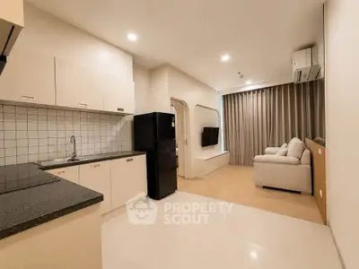 Modern open-plan kitchen and living room with sleek design and neutral tones