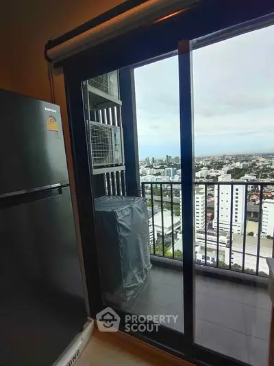 High-rise apartment balcony with stunning city view and modern appliances.