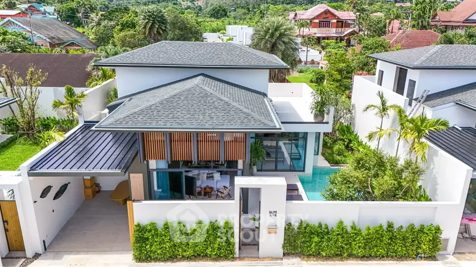 Luxurious modern villa with private pool and lush garden in tropical setting