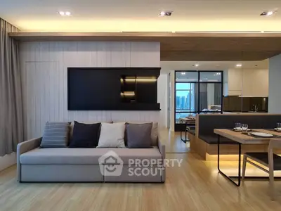 Modern living room with sleek design, open layout, and city view from kitchen area.