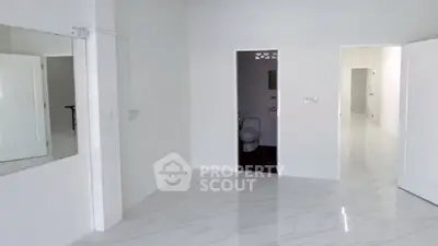 Spacious modern interior with sleek white flooring and open layout