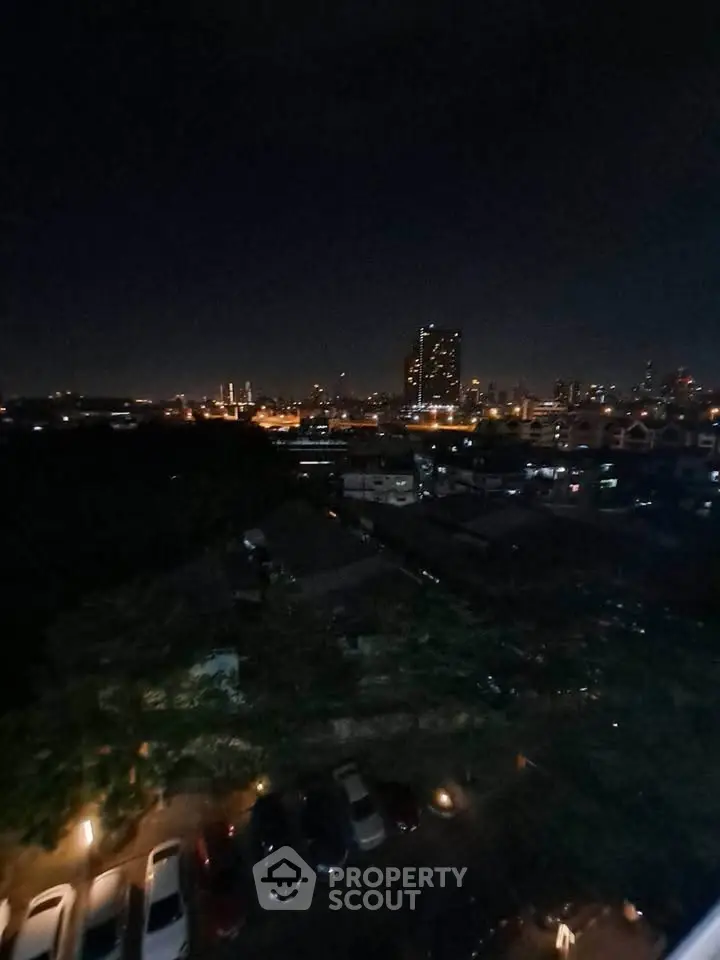 Stunning night cityscape view from high-rise building overlooking urban skyline.
