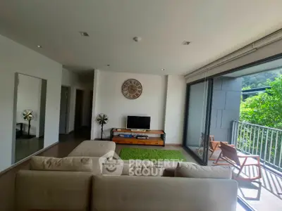 Spacious living room with modern decor and balcony view