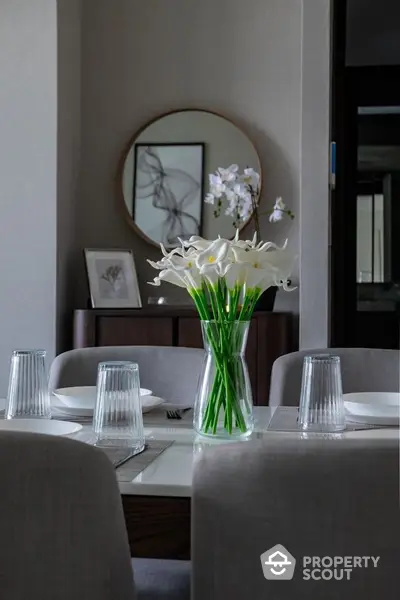 Elegant dining room with modern decor and floral centerpiece