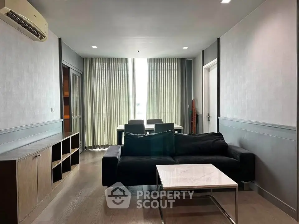 Modern living room with sleek furniture and natural light, perfect for relaxation and entertainment.