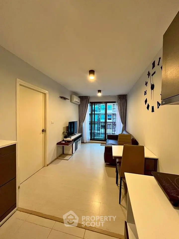 Modern living room with stylish decor and balcony view in a contemporary apartment.