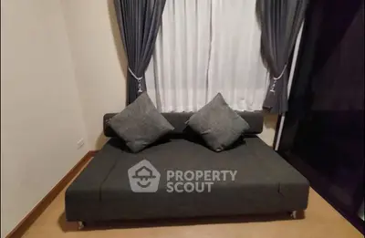 Cozy living room with stylish sofa and elegant curtains