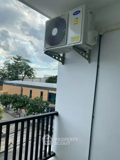 Modern balcony with air conditioning unit and city view
