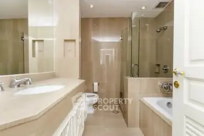 Luxurious bathroom with elegant fixtures and a spacious bathtub in a modern home.