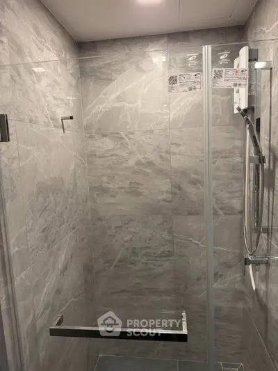Modern bathroom with sleek glass shower and marble tiles