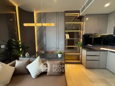 Luxurious modern living room with sleek kitchen, elegant lighting, and stylish decor.