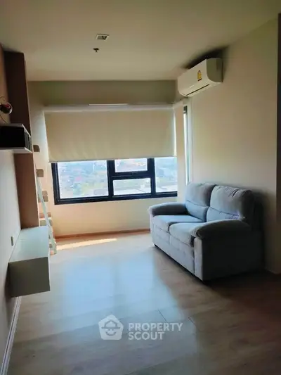 Bright living room with cozy sofa and large window view