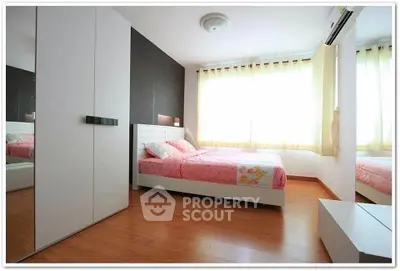 Bright and cozy bedroom with modern furnishings and large windows