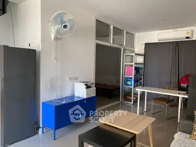 Modern living space with sleek furniture and wall-mounted fan, ideal for urban living.