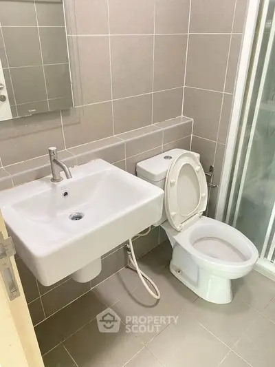Modern bathroom with sleek fixtures and tiled walls