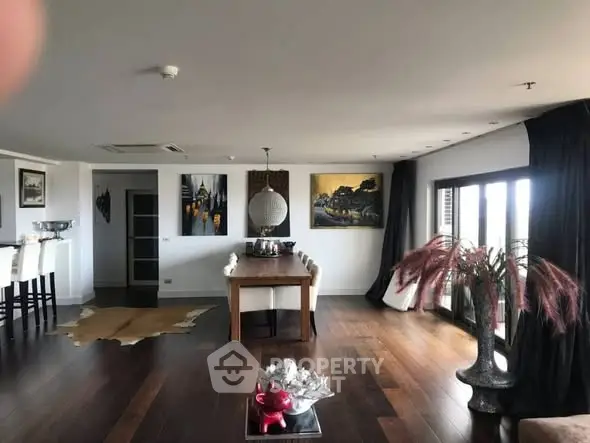 Spacious modern living room with elegant decor and large windows.