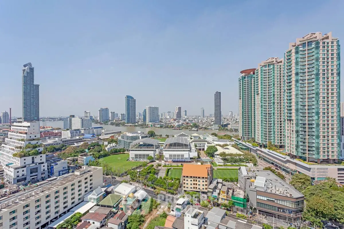 Stunning cityscape view with modern high-rise buildings and lush greenery, perfect for urban living.