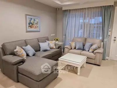 Elegant living room with cozy gray sofas and stylish decor in a modern apartment.