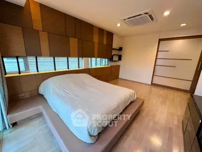 Modern bedroom with stylish wood paneling and minimalist design