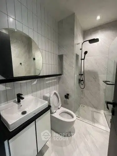 Modern bathroom with sleek fixtures and glass shower enclosure