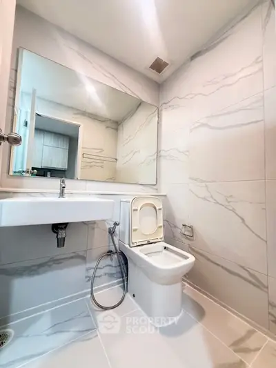 Modern bathroom with sleek marble tiles and contemporary fixtures