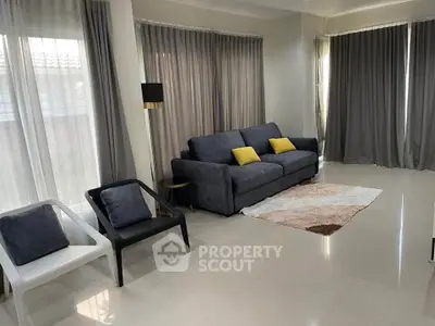 Spacious living room with modern furniture and large windows for natural light.