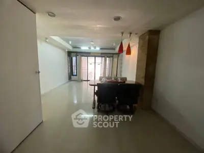 Spacious dining area with modern lighting and large windows for natural light.