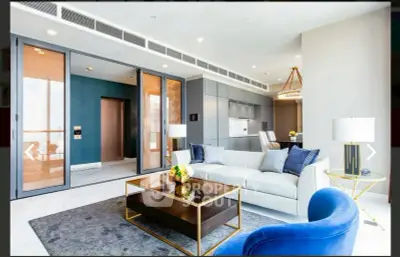 Luxurious modern living room with elegant furniture and open kitchen layout, perfect for stylish urban living.