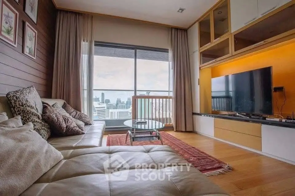 Luxurious living room with city view, featuring plush seating and modern entertainment setup.