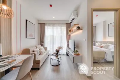 Bright and modern living room seamlessly connects to a cozy bedroom, featuring elegant furnishings and tasteful decor, perfect for urban living.