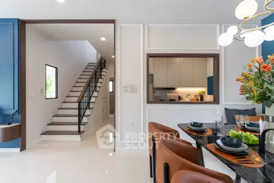 Modern dining area with elegant staircase and stylish kitchen in open layout