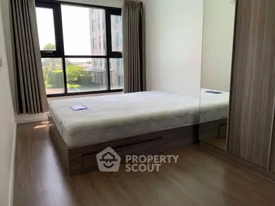 Modern bedroom with large window and mirrored wardrobe