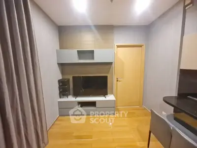 Modern living room with sleek TV unit and wooden flooring