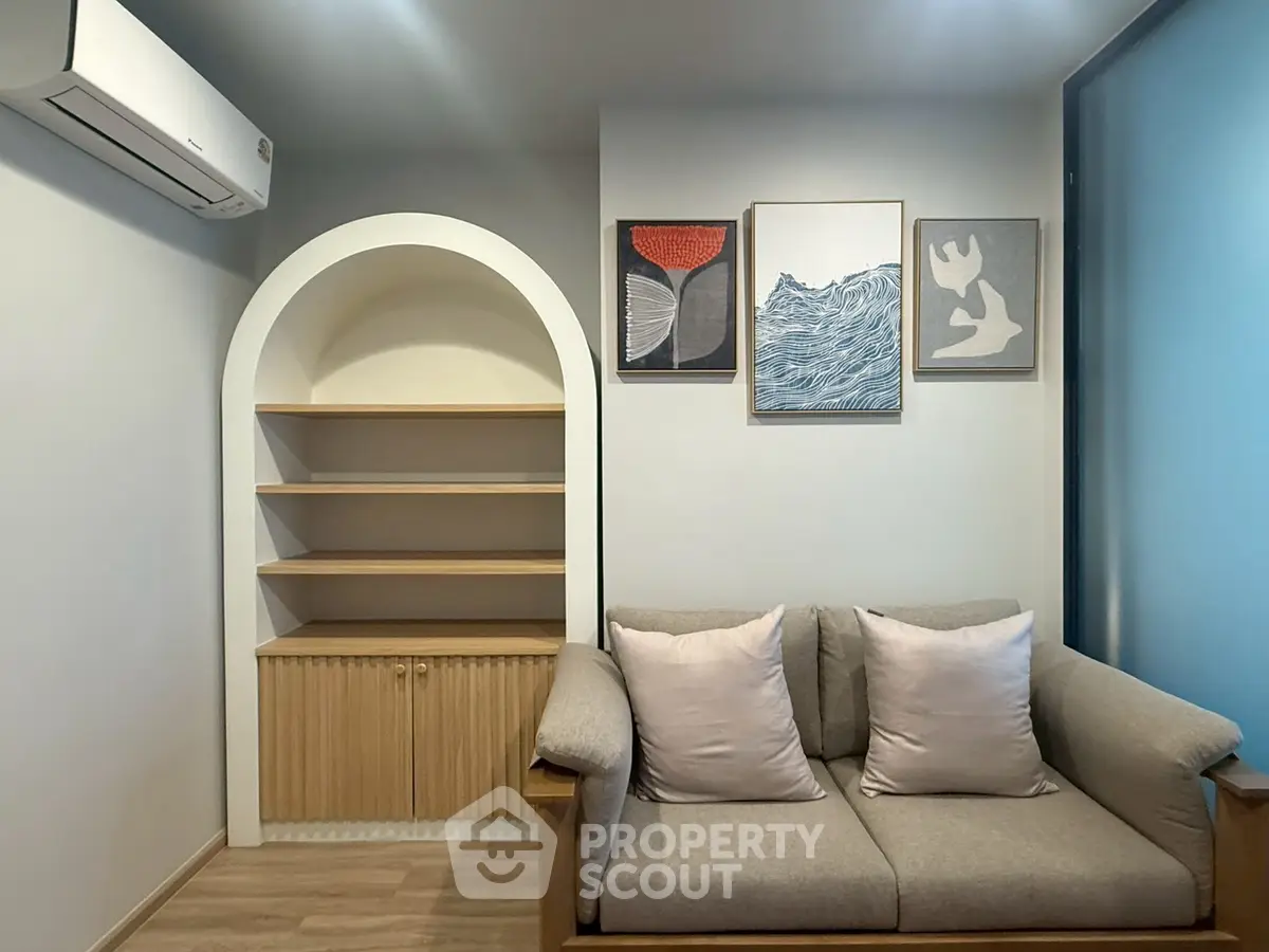 Cozy living room with stylish sofa and built-in shelves, perfect for modern living.