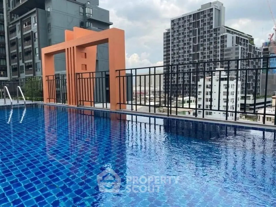Stunning rooftop pool with cityscape views in modern urban setting.