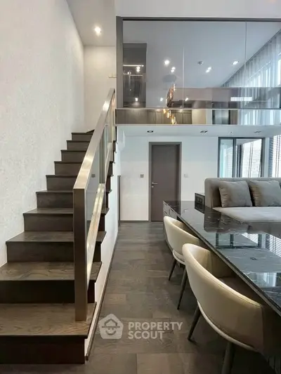 Modern duplex interior with sleek staircase and stylish dining area