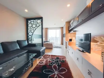 Modern open-plan living room with stylish decor and large windows.