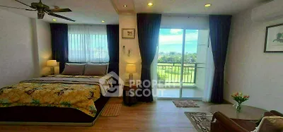 Spacious bedroom with balcony and scenic view, featuring modern decor and natural light.