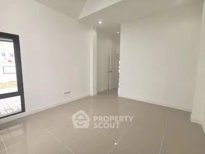 Spacious minimalist room with large window and tiled floor