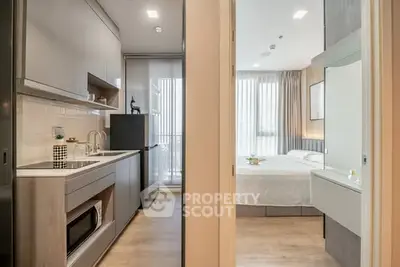 Modern studio apartment with sleek kitchen and cozy bedroom