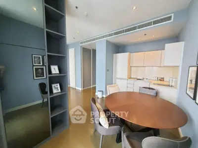 Modern dining area with sleek kitchen in open layout apartment