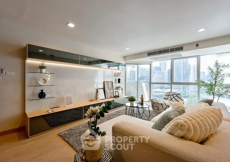 Spacious modern living room with city view, elegant decor, and natural light.