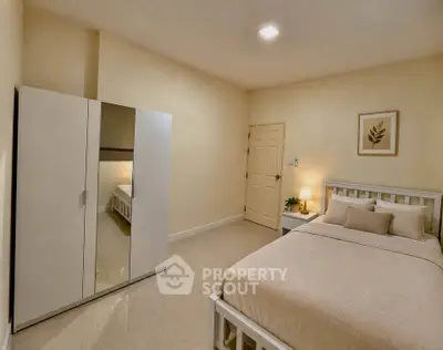 Cozy bedroom with minimalist decor and mirrored wardrobe