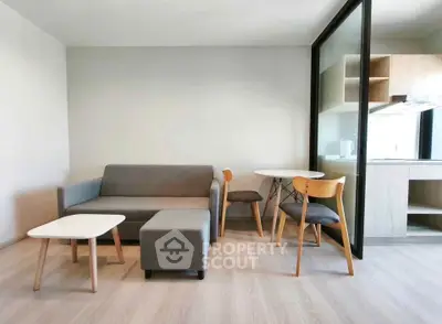 Modern living room with sleek furniture and open kitchen layout