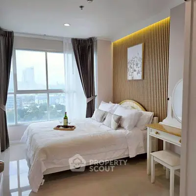 Luxurious bedroom with city view, elegant decor, and natural light.